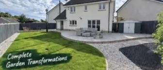 Curved lawn and light patio beside a cream detached house, with gravel and a dark mulch bed in the foreground.